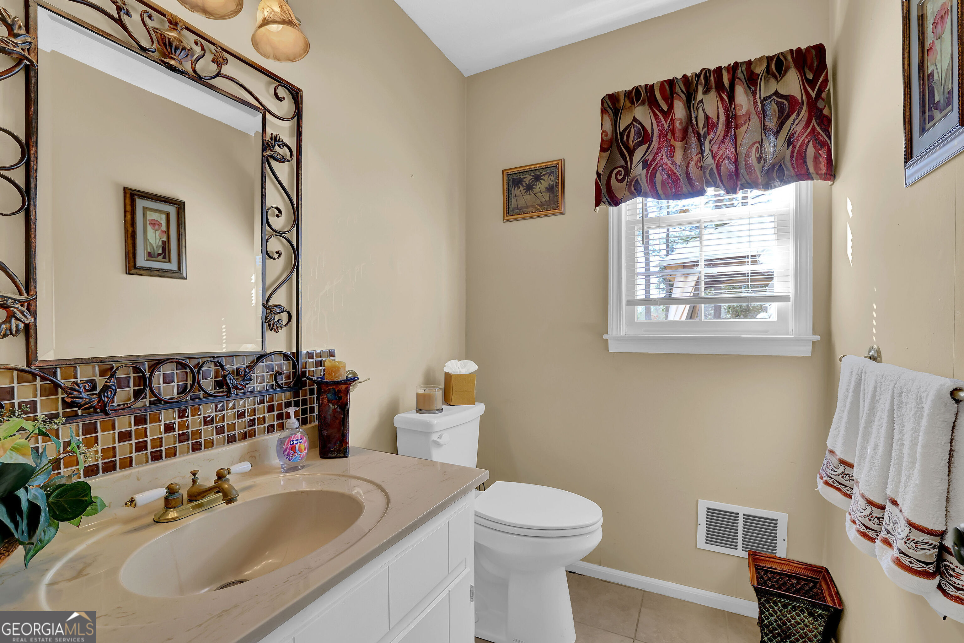 2613 Travois Way Southwest Lilburn, GA 30047 - Photo 38 of 40 a bathroom with a sink and a mirror