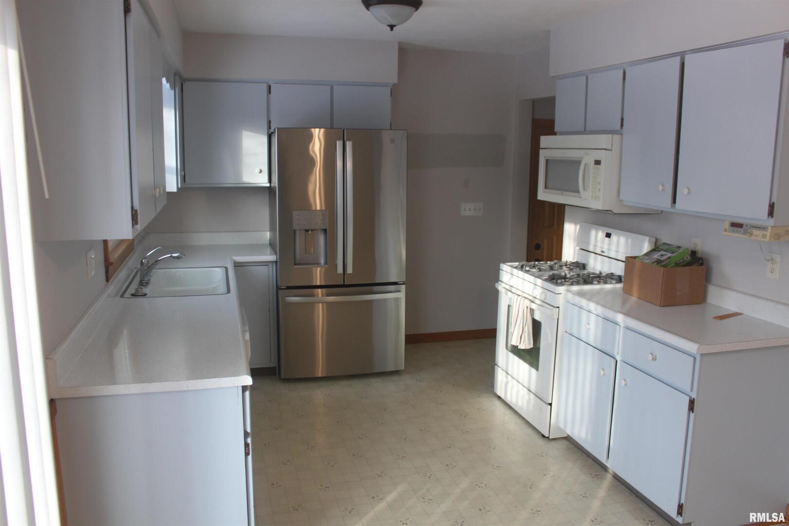9012 98th Street West Taylor Ridge, IL 61284 - Photo 14 of 18 a kitchen with cabinets and stainless steel appliances