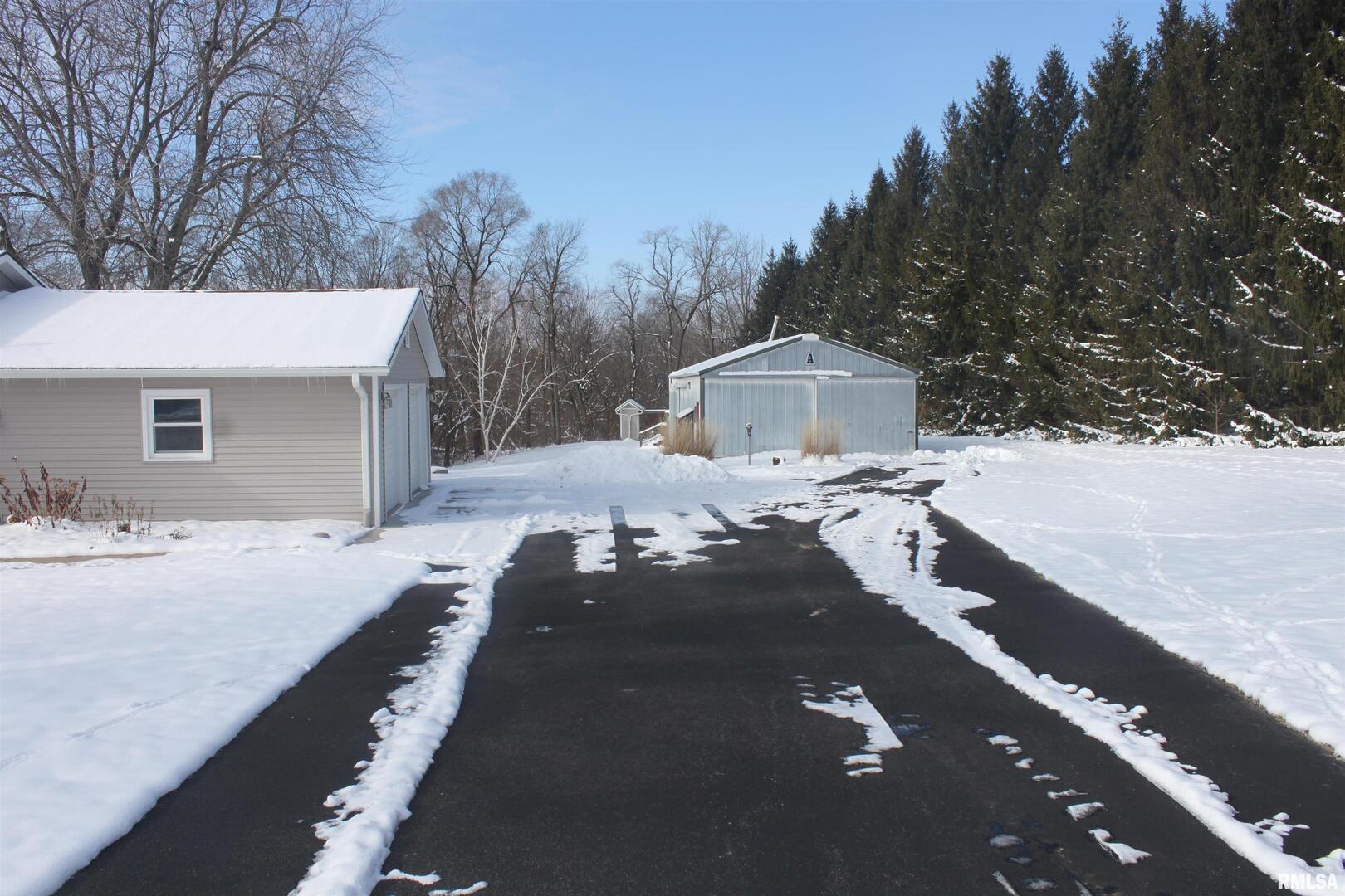 9012 98th Street West Taylor Ridge, IL 61284 - Photo 2 of 18 a view of a house with a snow