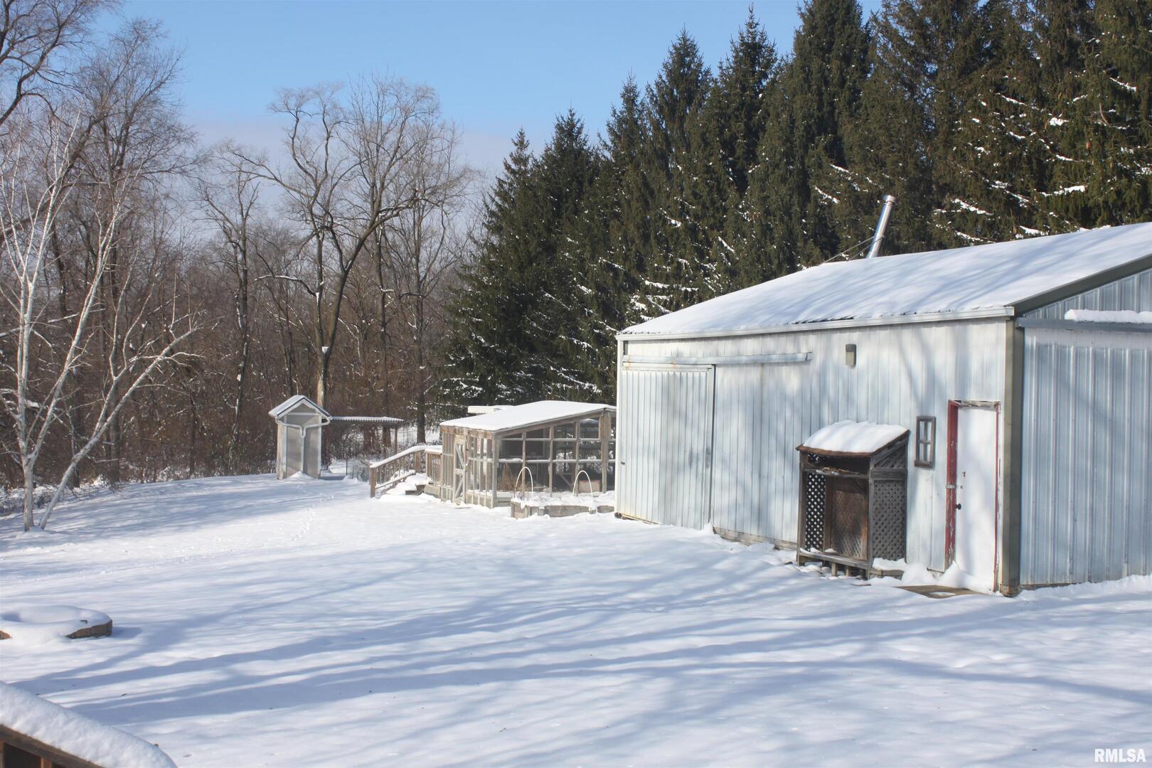 9012 98th Street West Taylor Ridge, IL 61284 - Photo 3 of 18 a wooden bench sitting in front of a building