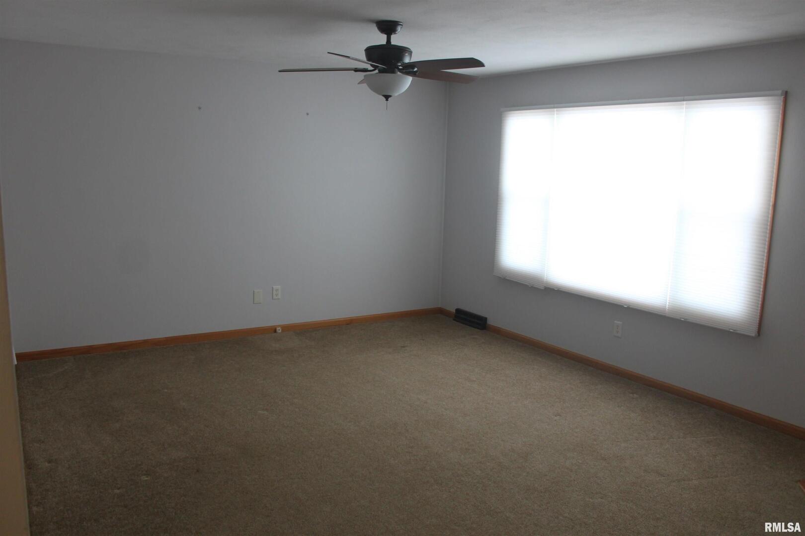9012 98th Street West Taylor Ridge, IL 61284 - Photo 6 of 18 an empty room with a window