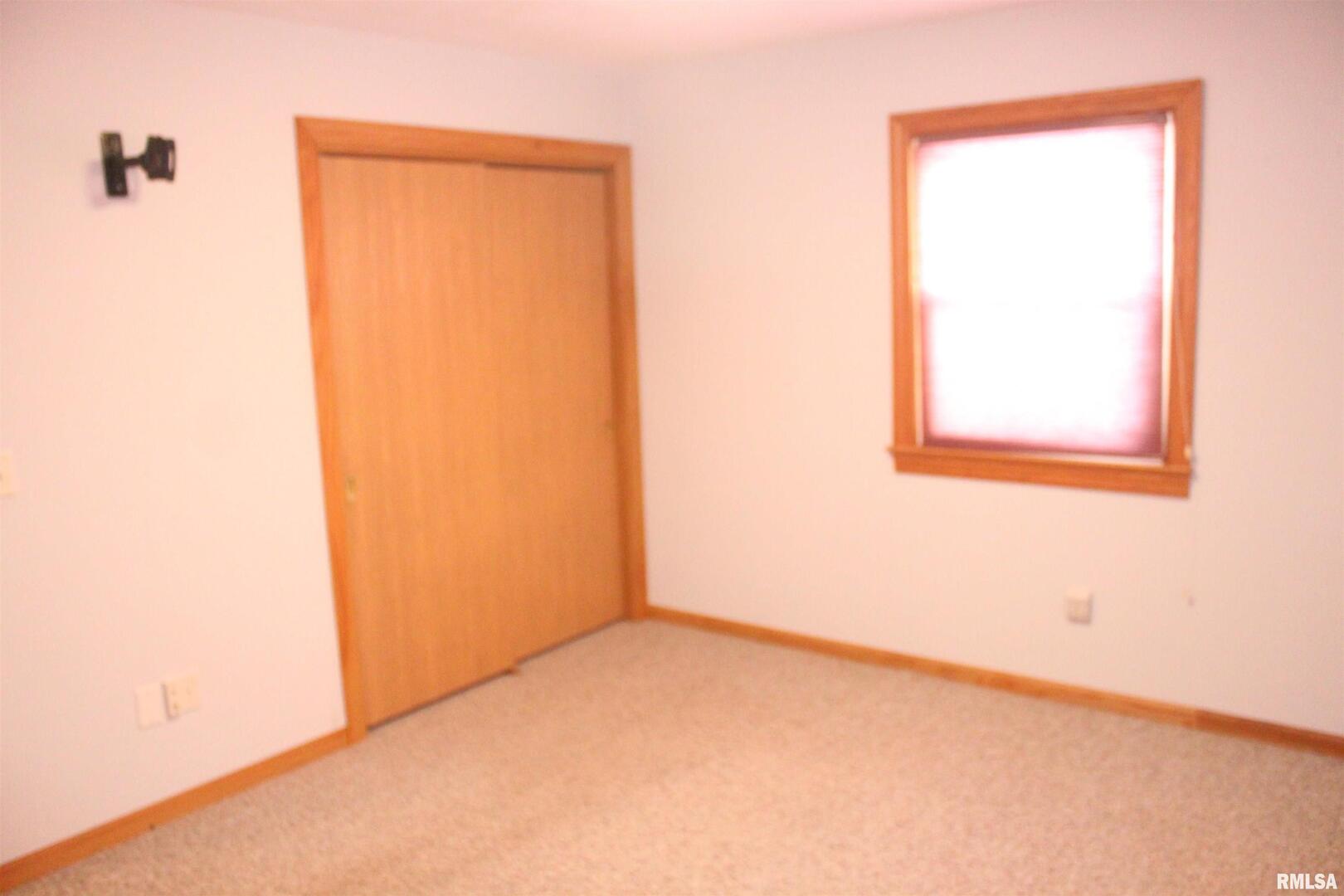 9012 98th Street West Taylor Ridge, IL 61284 - Photo 9 of 18 an empty room with a window