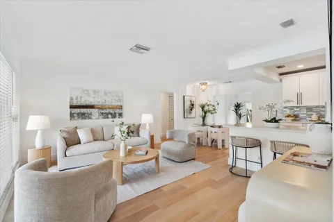 a living room with furniture and view of kitchen