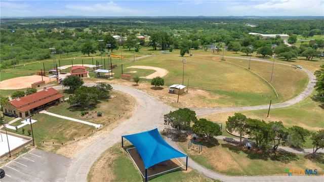 an aerial view of a house with a swimming pool
