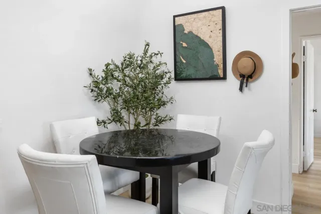 a dining room with furniture and wooden floor