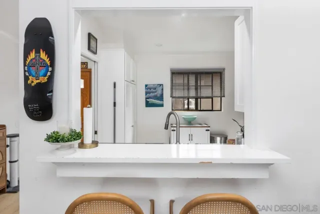 a en suite bathroom with a granite countertop sink and mirror