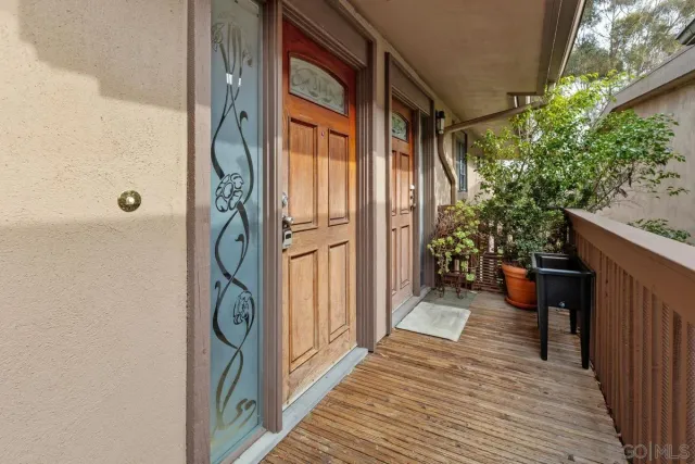 a view of a porch with wooden floor and furniture