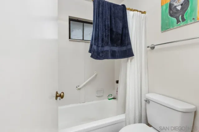 a bathroom with a toilet and a bathtub