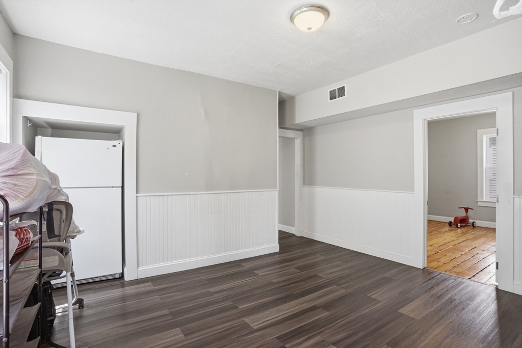 196 Irving Street Fall River, MA 02723 - Photo 8 of 34 an empty room with wooden floor and gym equipment
