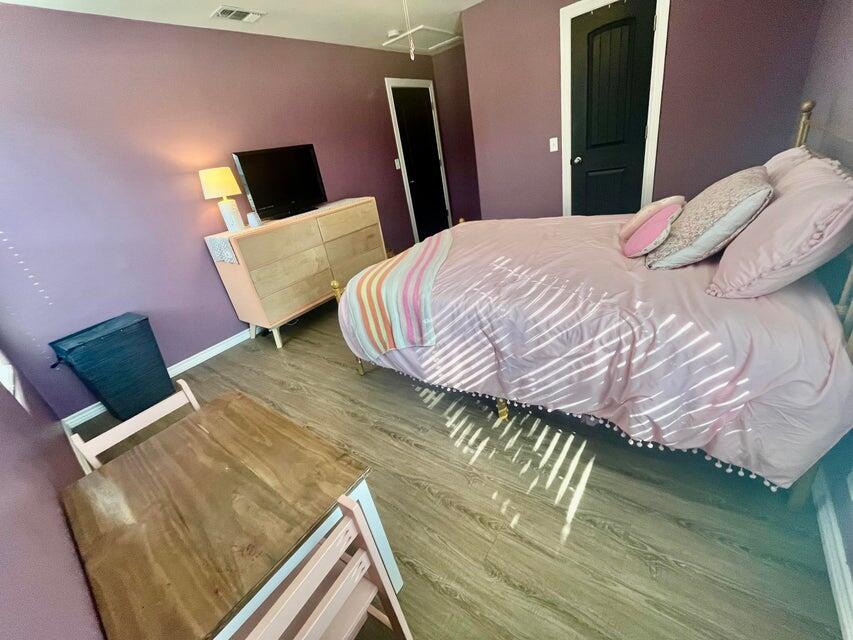 1209 Xenia Street Plainview, TX 79072 - Photo 19 of 31 a bedroom with a bed and a television