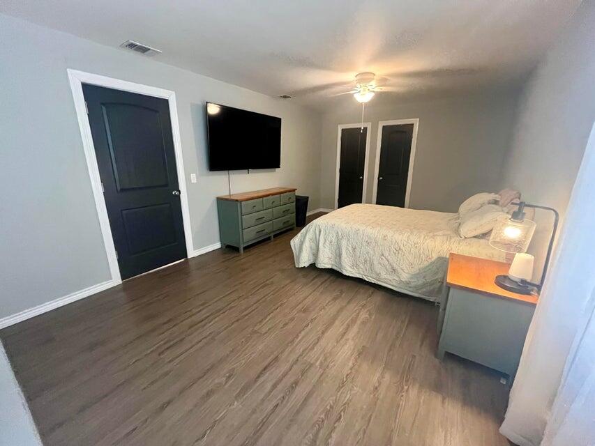 1209 Xenia Street Plainview, TX 79072 - Photo 22 of 31 a bedroom with a bed and a flat screen tv