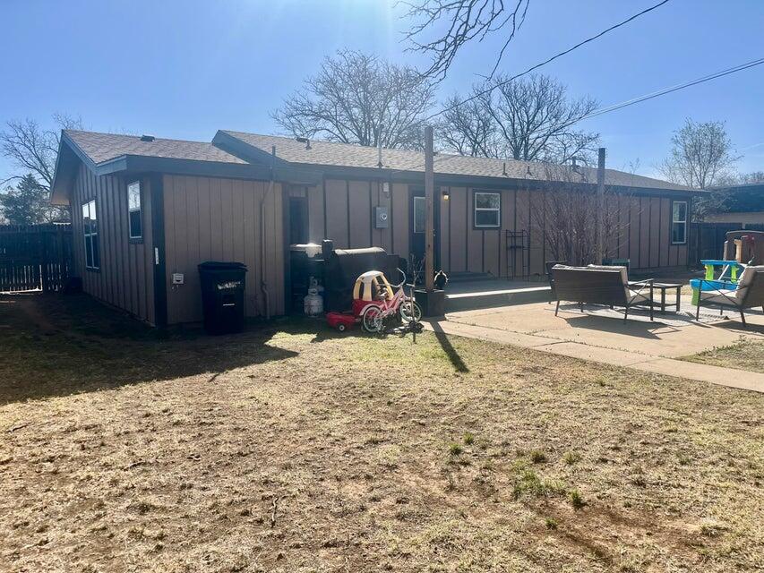 1209 Xenia Street Plainview, TX 79072 - Photo 28 of 31 a backyard of a house with barbeque oven and outdoor seating