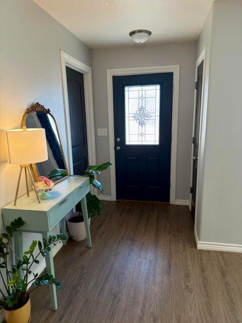 1209 Xenia Street Plainview, TX 79072 - Photo 4 of 31 wooden floor in an empty room with a window