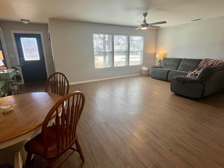 1209 Xenia Street Plainview, TX 79072 - Photo 5 of 31 a living room with furniture and wooden floor