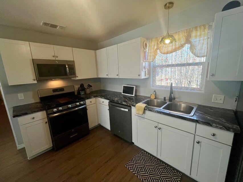 1209 Xenia Street Plainview, TX 79072 - Photo 9 of 31 a kitchen with a sink stove and microwave
