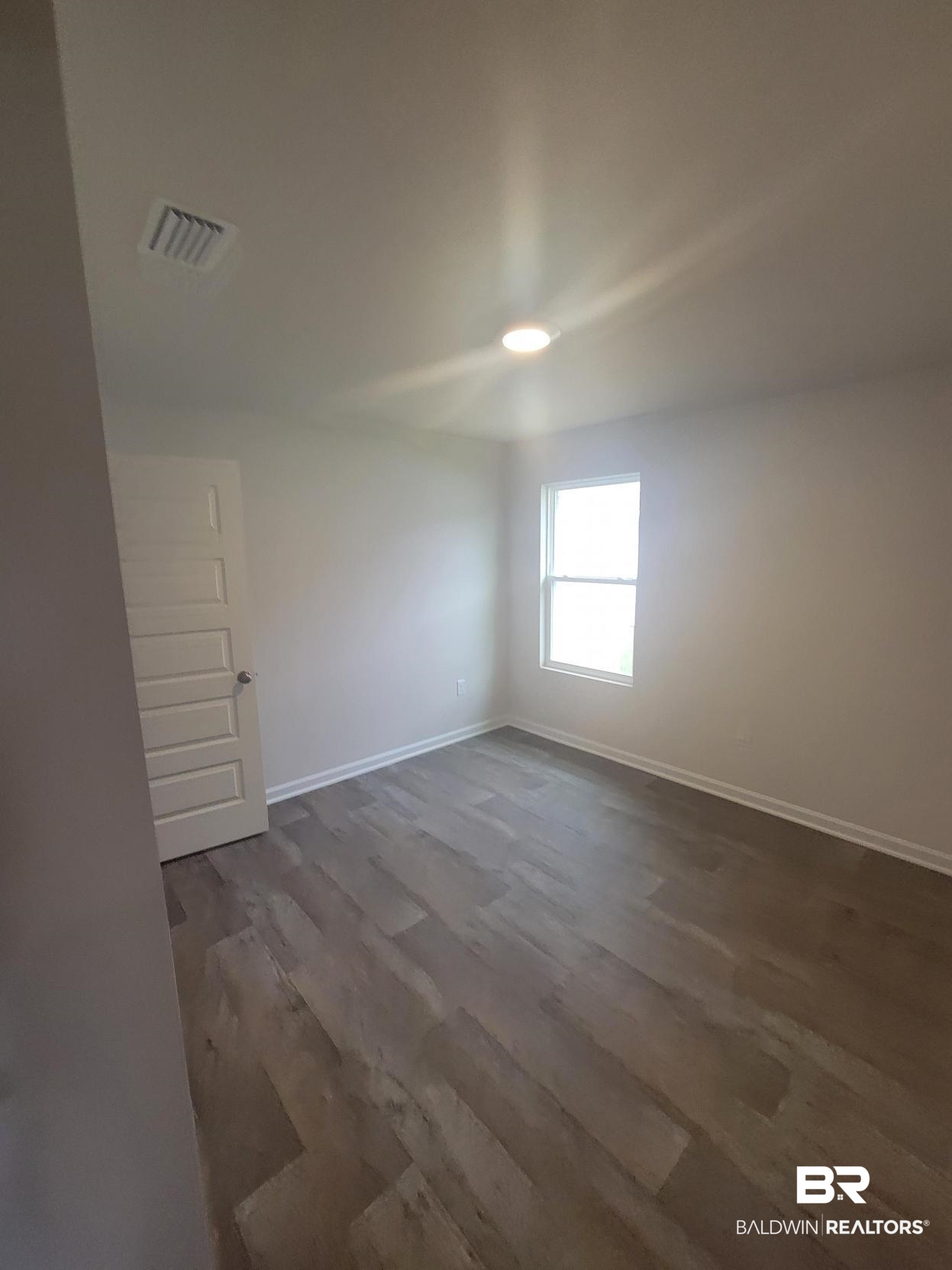 24625 Ponder Loop Loxley, AL 36551 - Photo 29 of 30 Unfurnished room featuring dark hardwood / wood-style flooring