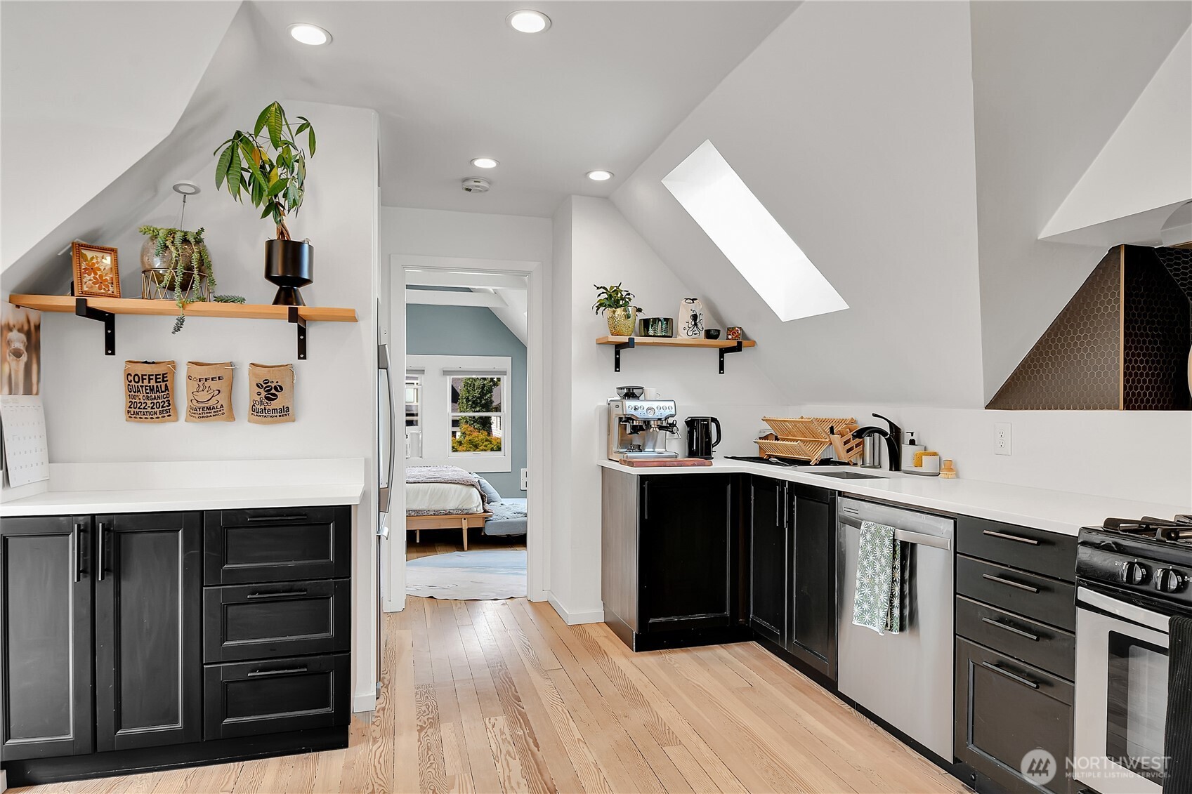 1930 5th Avenue West Seattle, WA 98119 - Photo 15 of 28 a kitchen with stainless steel appliances granite countertop a stove and a refrigerator