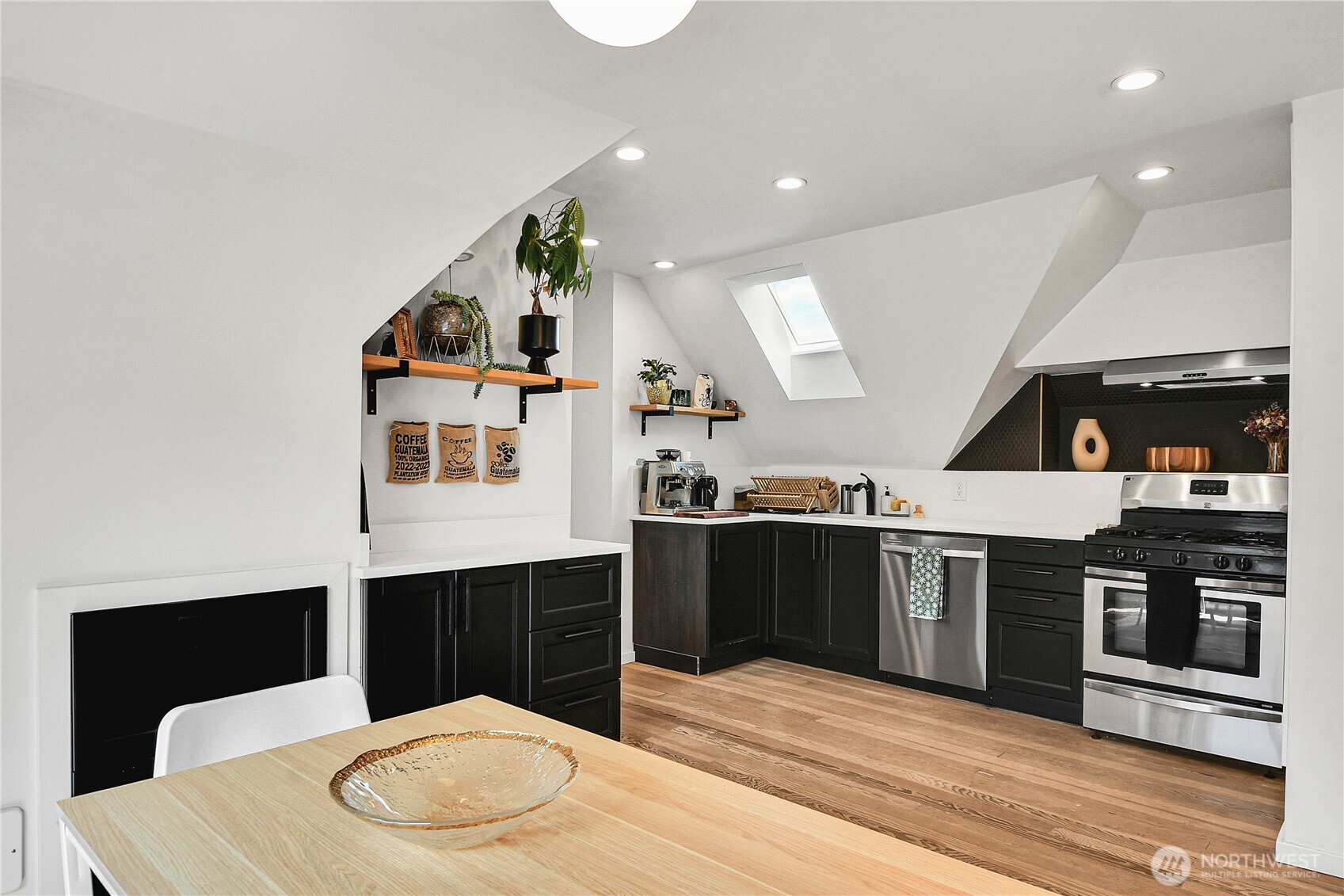 1930 5th Avenue West Seattle, WA 98119 - Photo 16 of 28 a kitchen with stainless steel appliances kitchen island a stove and a sink