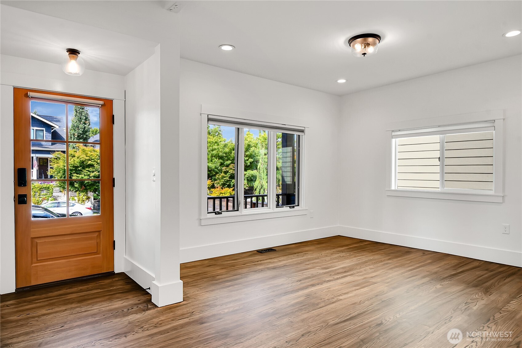 1930 5th Avenue West Seattle, WA 98119 - Photo 4 of 28 a view of an empty room with wooden floor and a window