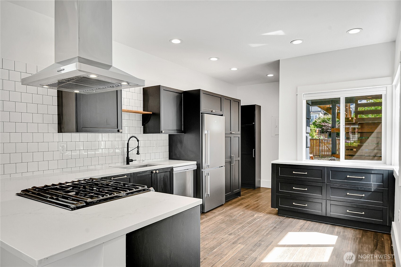 1930 5th Avenue West Seattle, WA 98119 - Photo 6 of 28 a kitchen with stainless steel appliances a stove a sink and a refrigerator