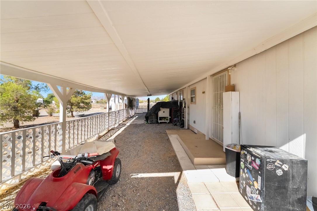 1551 West Wilson Road Pahrump, NV 89048 - Photo 39 of 68 A long covered carport provides sheltered parking and storage alongside the home.