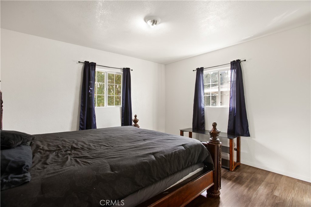 34863 Wildwood Canyon Road Yucaipa, CA 92399 - Photo 13 of 21 a bedroom with a bed and a window