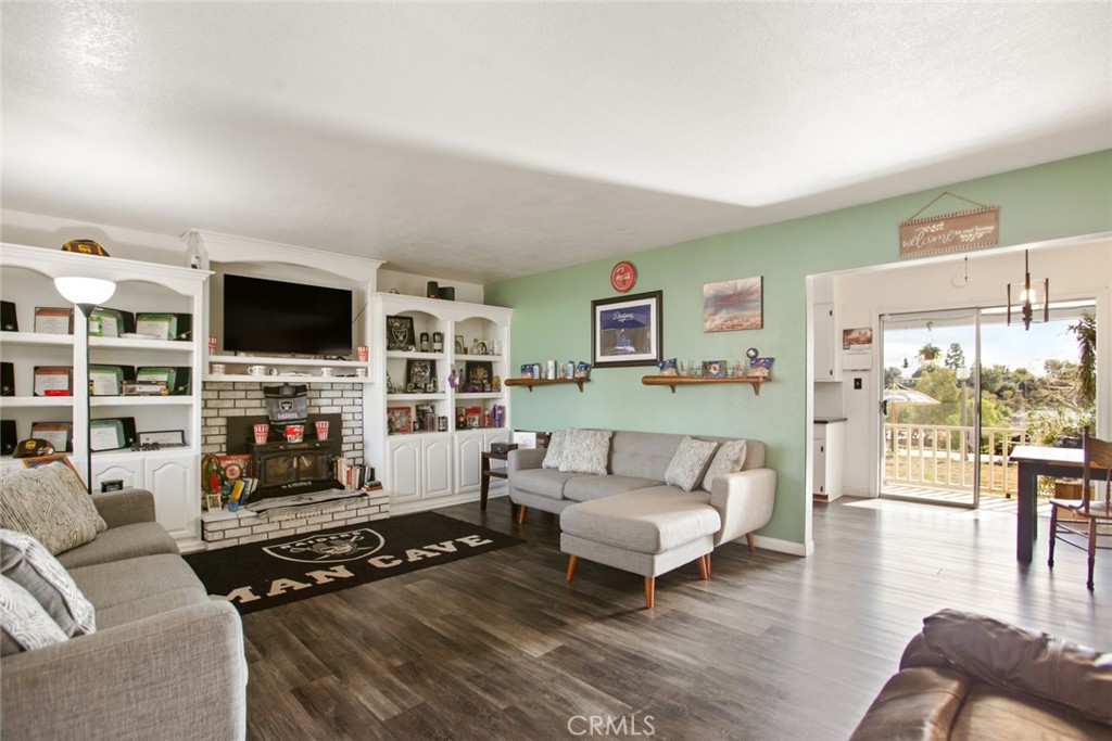 34863 Wildwood Canyon Road Yucaipa, CA 92399 - Photo 3 of 21 a living room with furniture flat screen tv and a fireplace