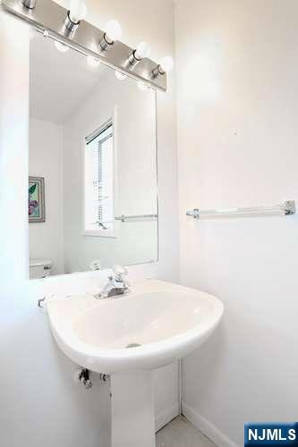 290 Hamilton Place, Unit 4 Hackensack, NJ 07601 - Photo 18 of 50 a bathroom with a sink and a mirror
