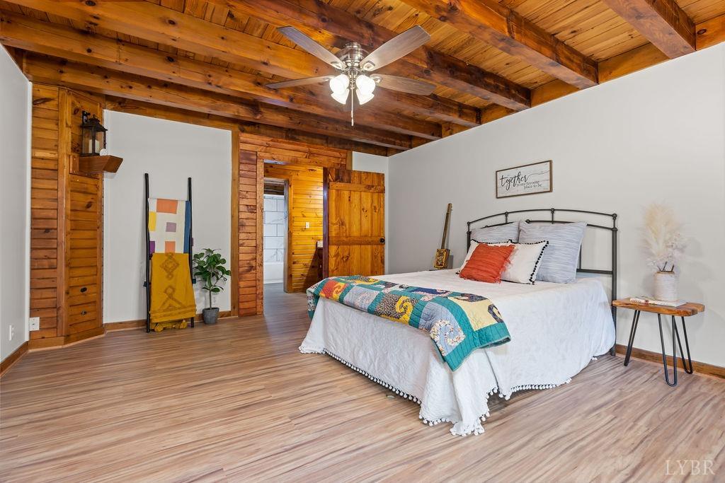 564 Thistle Road Rustburg, VA 24588 - Photo 34 of 47 a bedroom with a bed and wooden floor