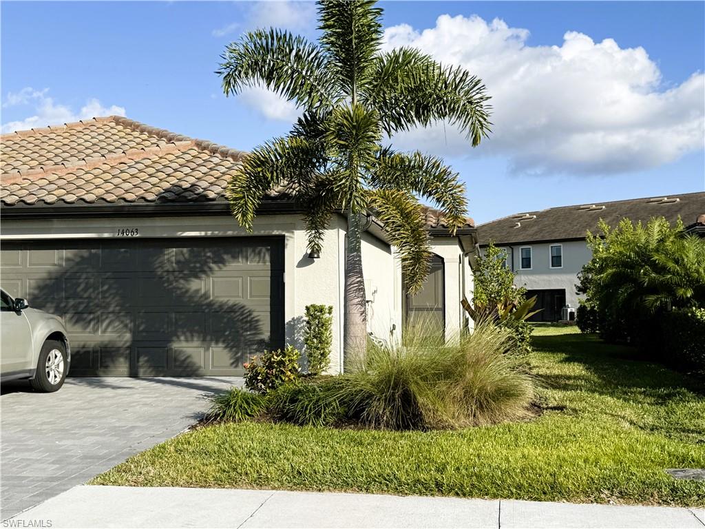 14063 Winding Cedar Way Fort Myers, FL 33913 - Photo 1 of 15 a view of a house with a yard
