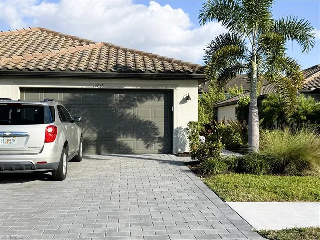a view of a kitchen with a sink and dishwasher a stove top oven with wooden floor
