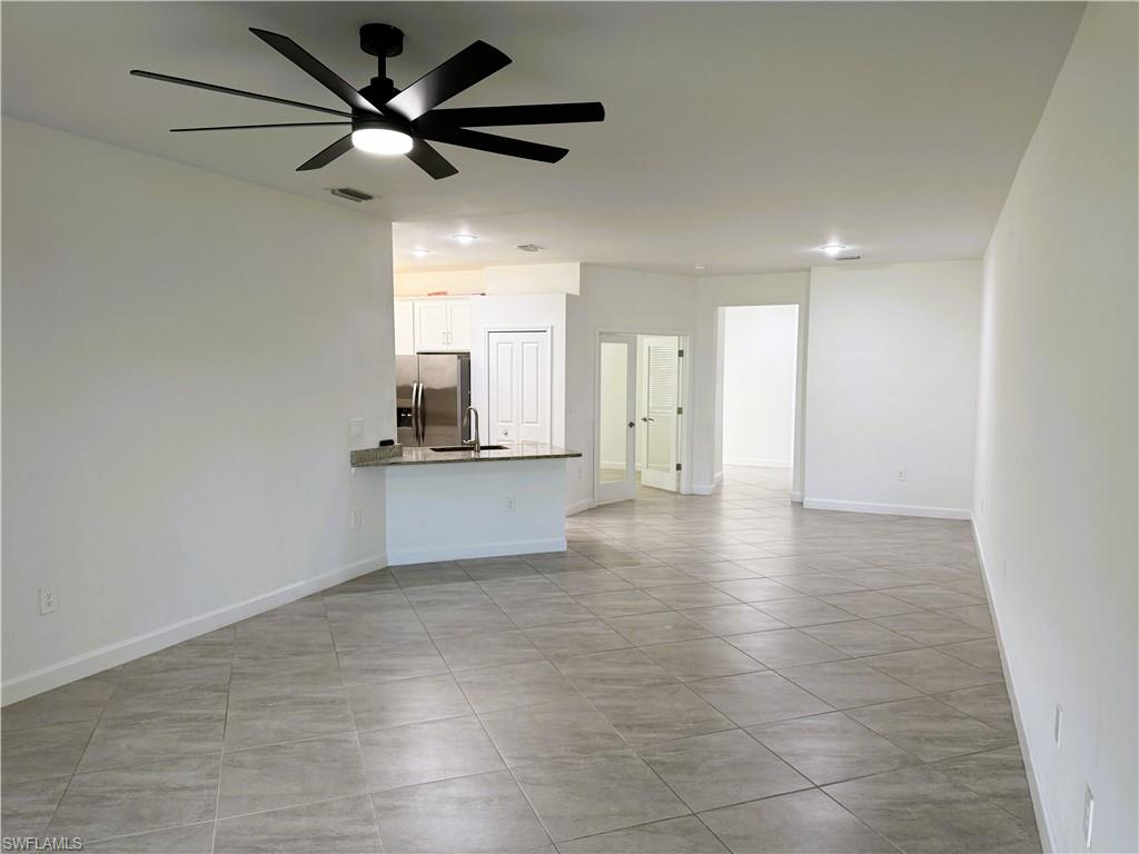 14063 Winding Cedar Way Fort Myers, FL 33913 - Photo 5 of 15 a view of a kitchen with a sink and a kitchen counter top space