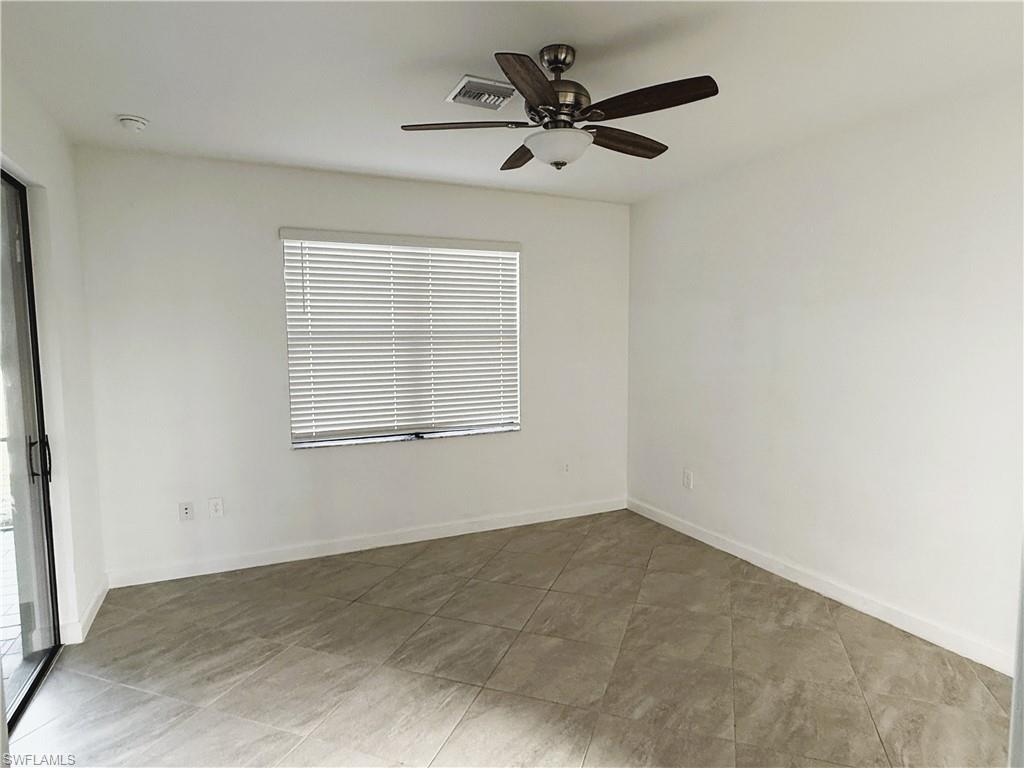 14063 Winding Cedar Way Fort Myers, FL 33913 - Photo 8 of 15 an empty room with a window and a fan