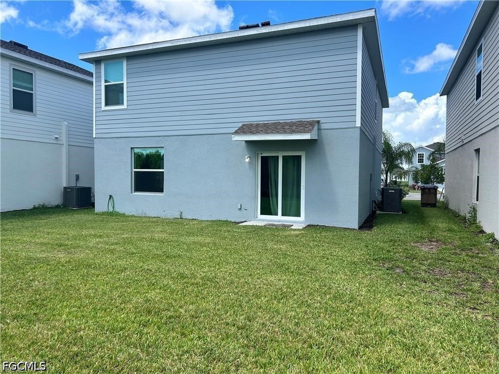 12441 Dakota Ridge Place Lehigh Acres, FL 33974 - Photo 15 of 16 a view of a house with a backyard