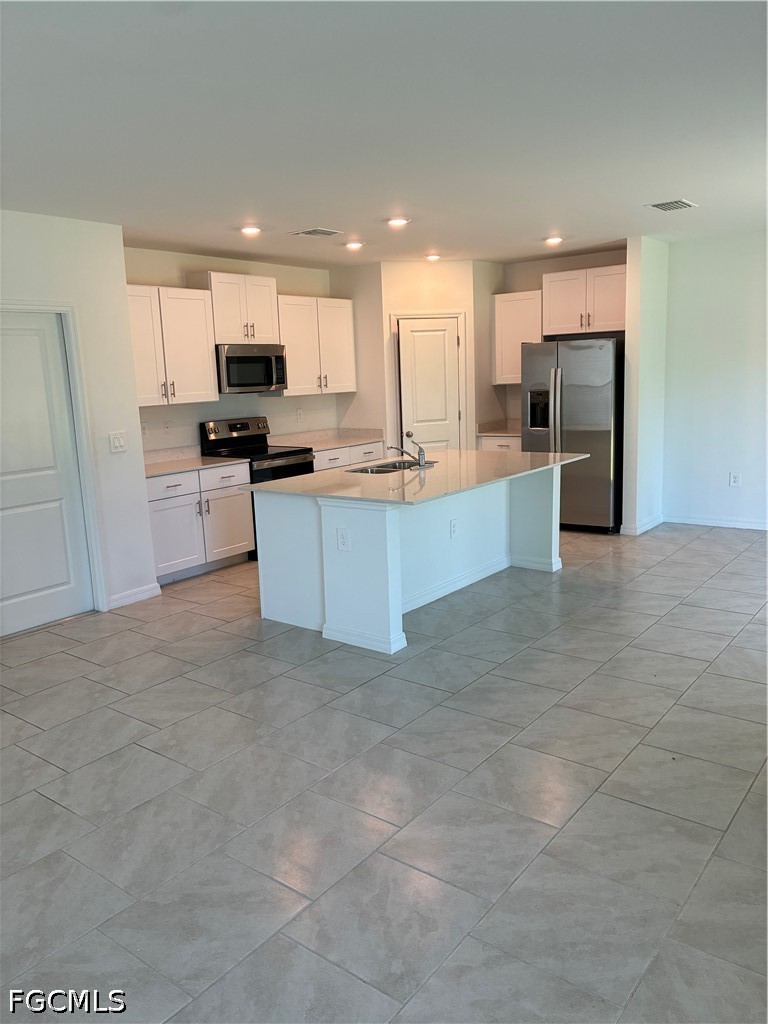 12441 Dakota Ridge Place Lehigh Acres, FL 33974 - Photo 6 of 16 a large kitchen with stainless steel appliances lots of counter top space