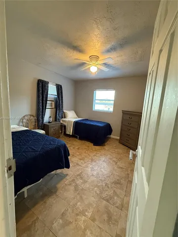a bedroom with two beds and a chandelier