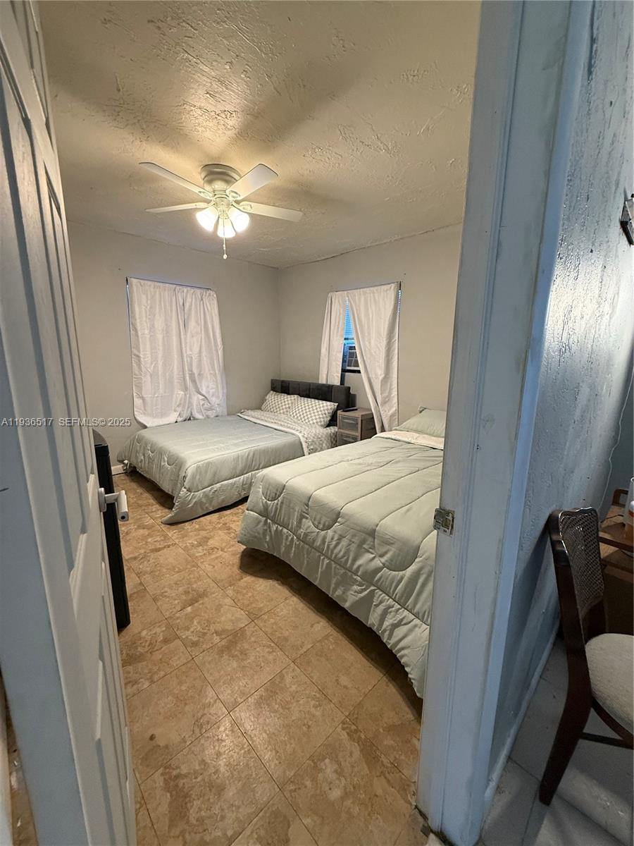 911 North 18th Street, Unit A Fort Pierce, FL 34950 - Photo 6 of 7 a bedroom with a bed and a chandelier