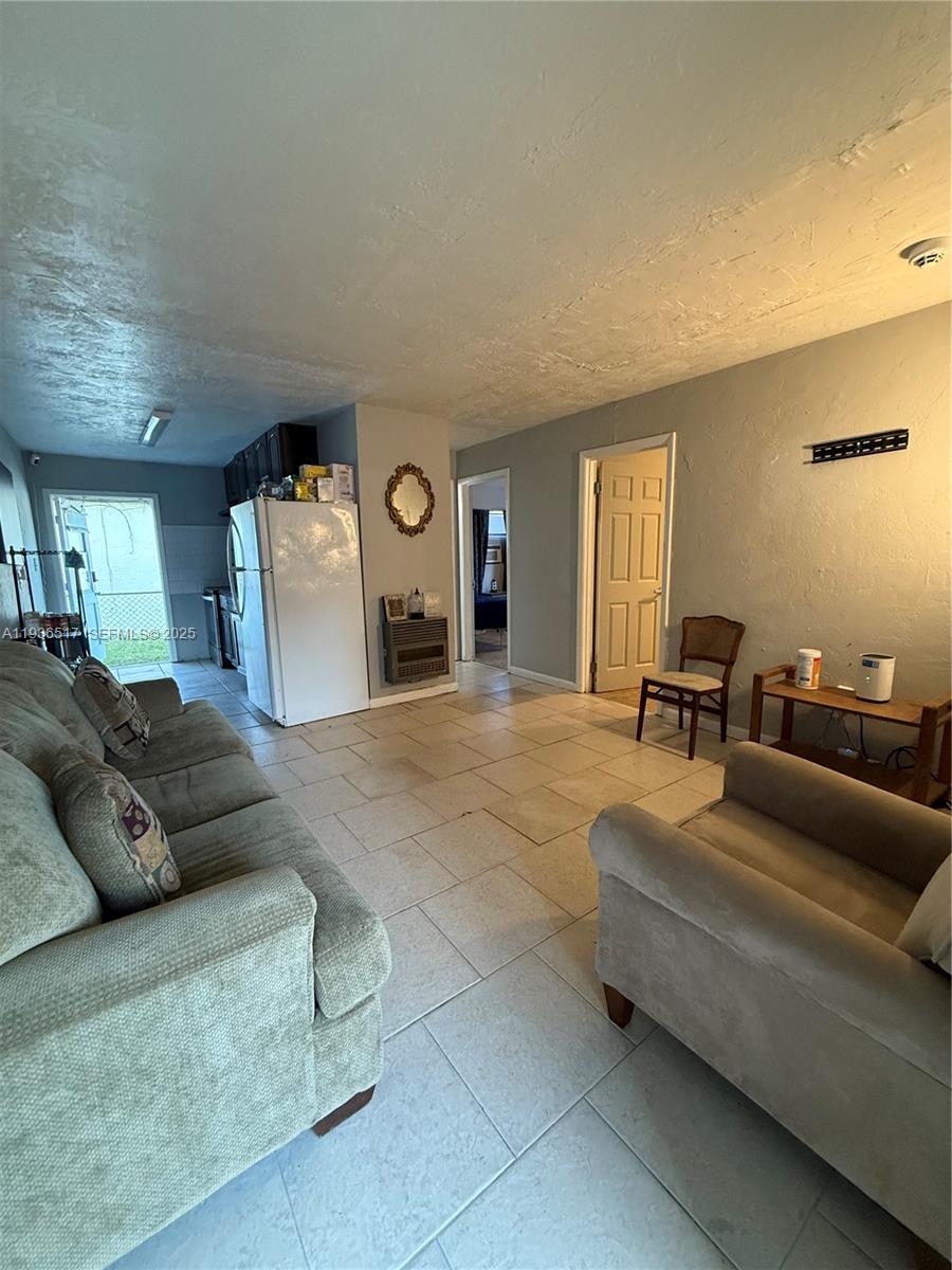 911 North 18th Street, Unit A Fort Pierce, FL 34950 - Photo 7 of 7 a living room with furniture and a couch