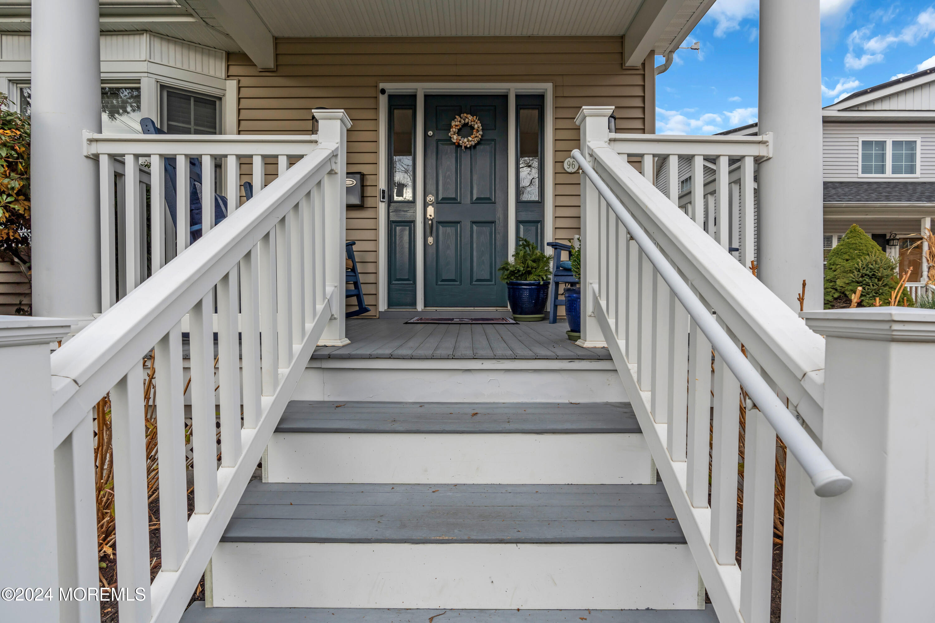 96 Manito Road Manasquan, NJ 08736 - Photo 2 of 50 a view of staircase with lots of frames on wall and windows