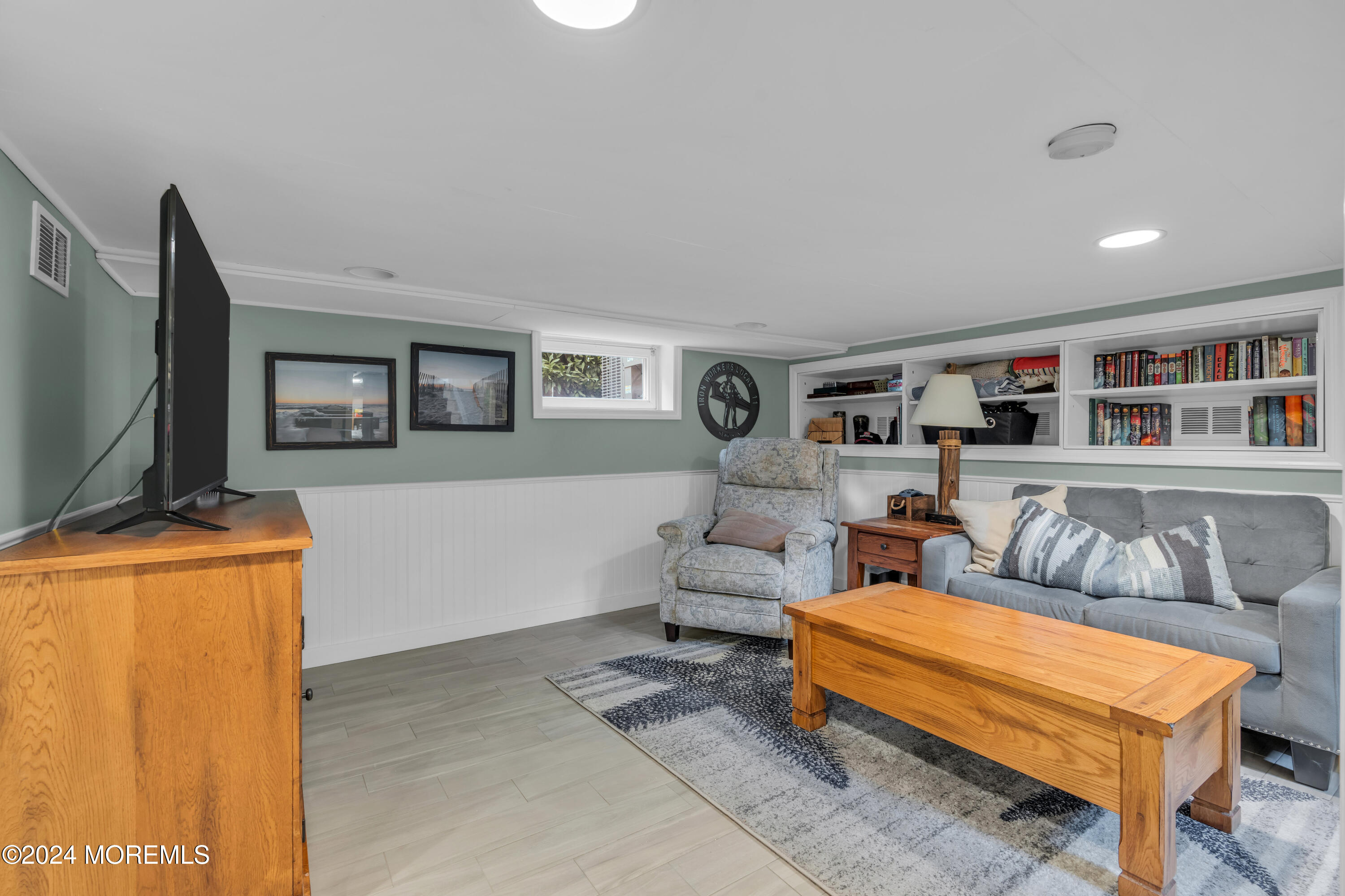 96 Manito Road Manasquan, NJ 08736 - Photo 40 of 50 a living room with furniture and a flat screen tv