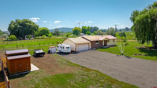 a view of a house with a yard and sitting area