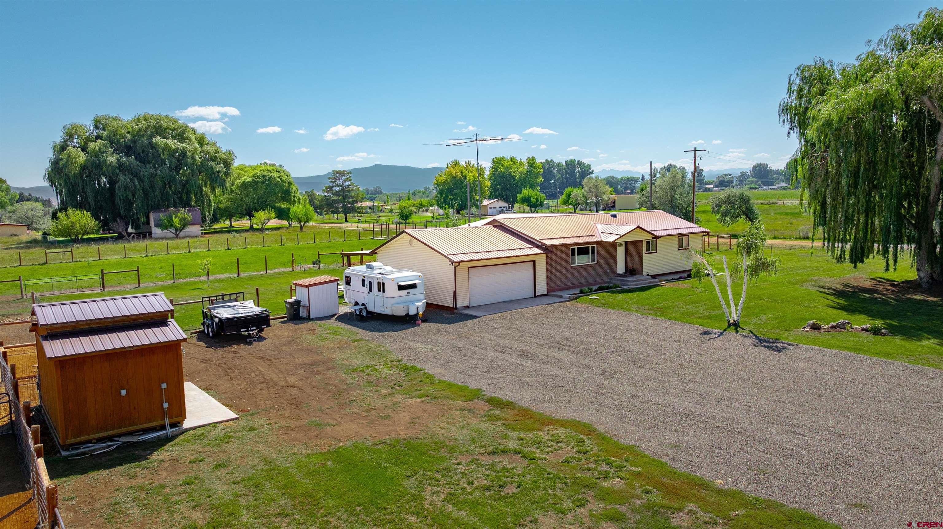 a view of a house with a yard and sitting area
