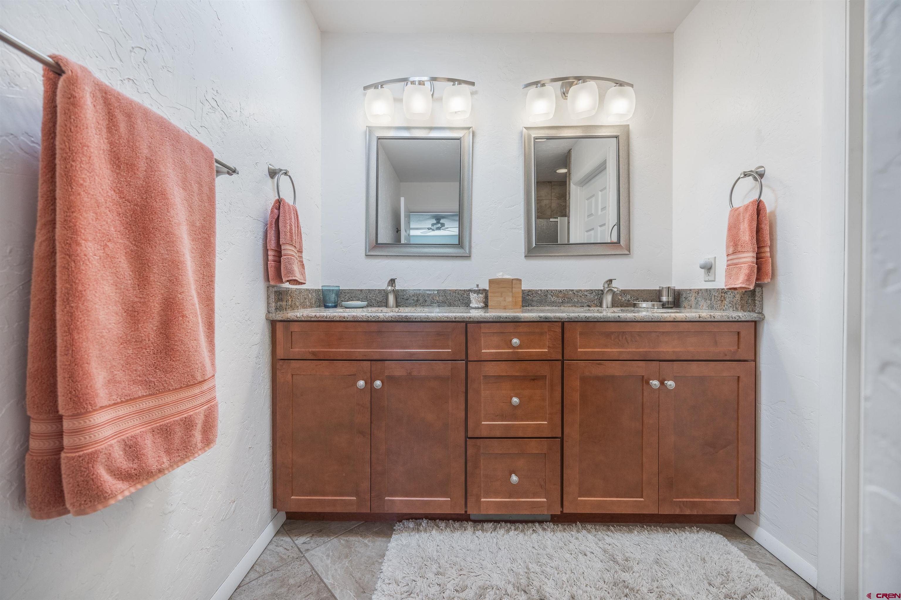 16574 6275th Road Montrose, CO 81403 - Photo 15 of 45 a bathroom with a double vanity sink and a mirror