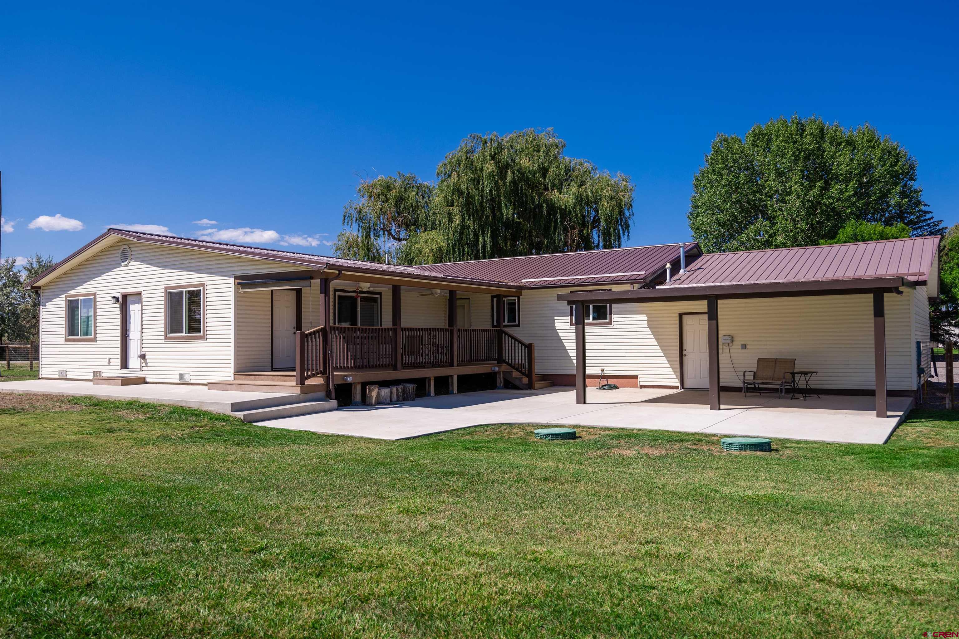 16574 6275th Road Montrose, CO 81403 - Photo 29 of 45 a view of a house with a yard and sitting area