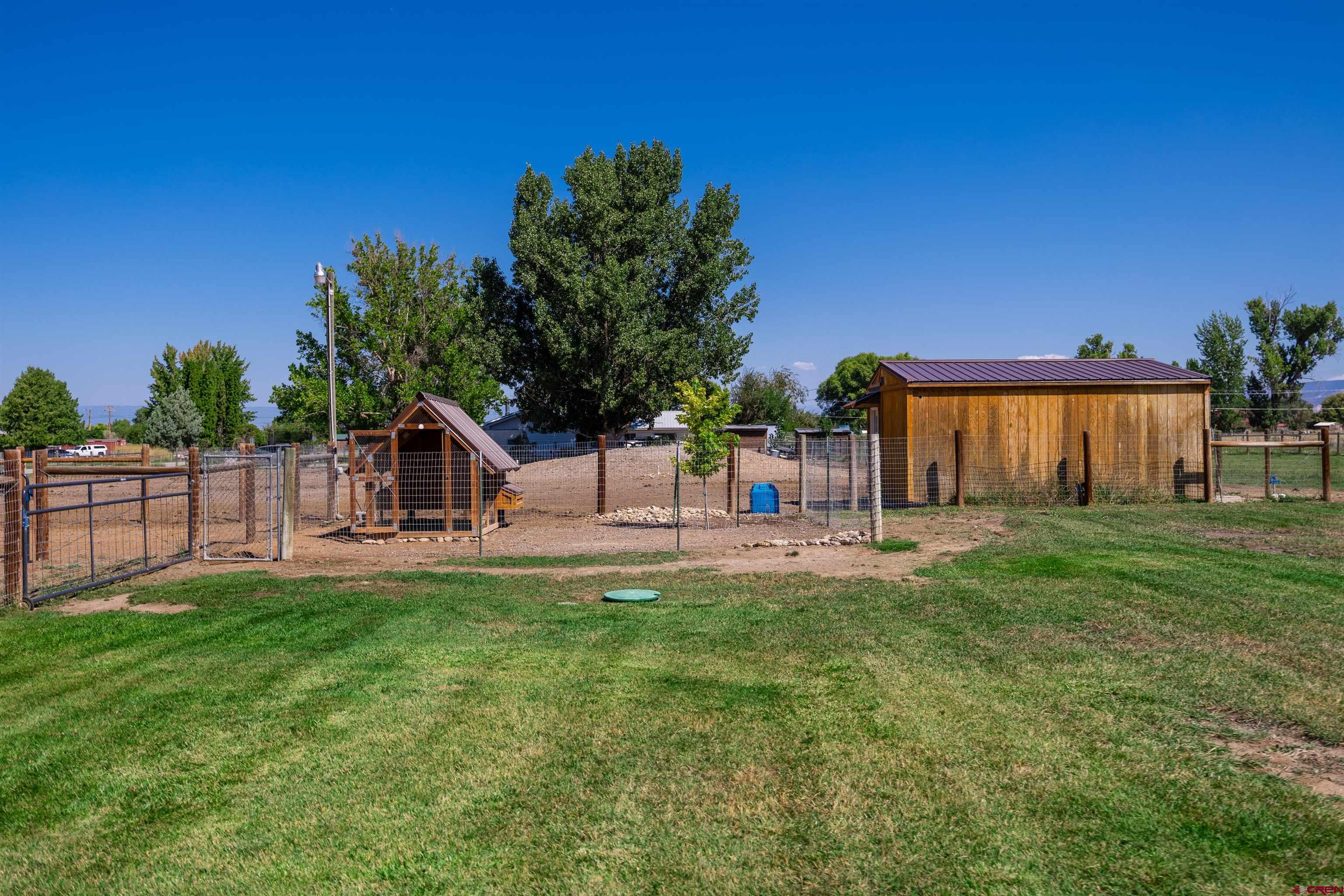 16574 6275th Road Montrose, CO 81403 - Photo 32 of 45 a view of a house with a yard and a garden