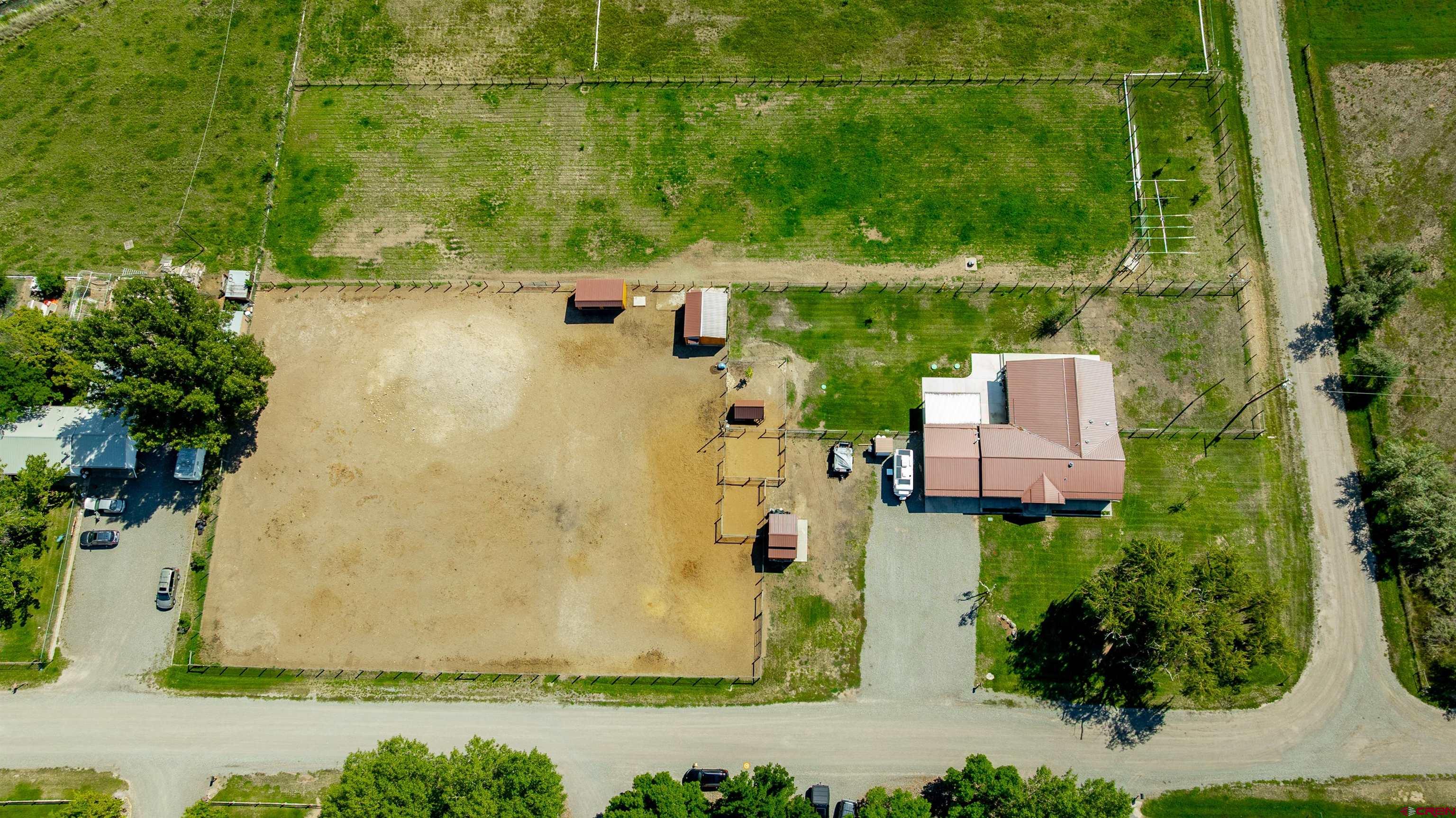 16574 6275th Road Montrose, CO 81403 - Photo 35 of 45 an aerial view of a house with a yard and lake view