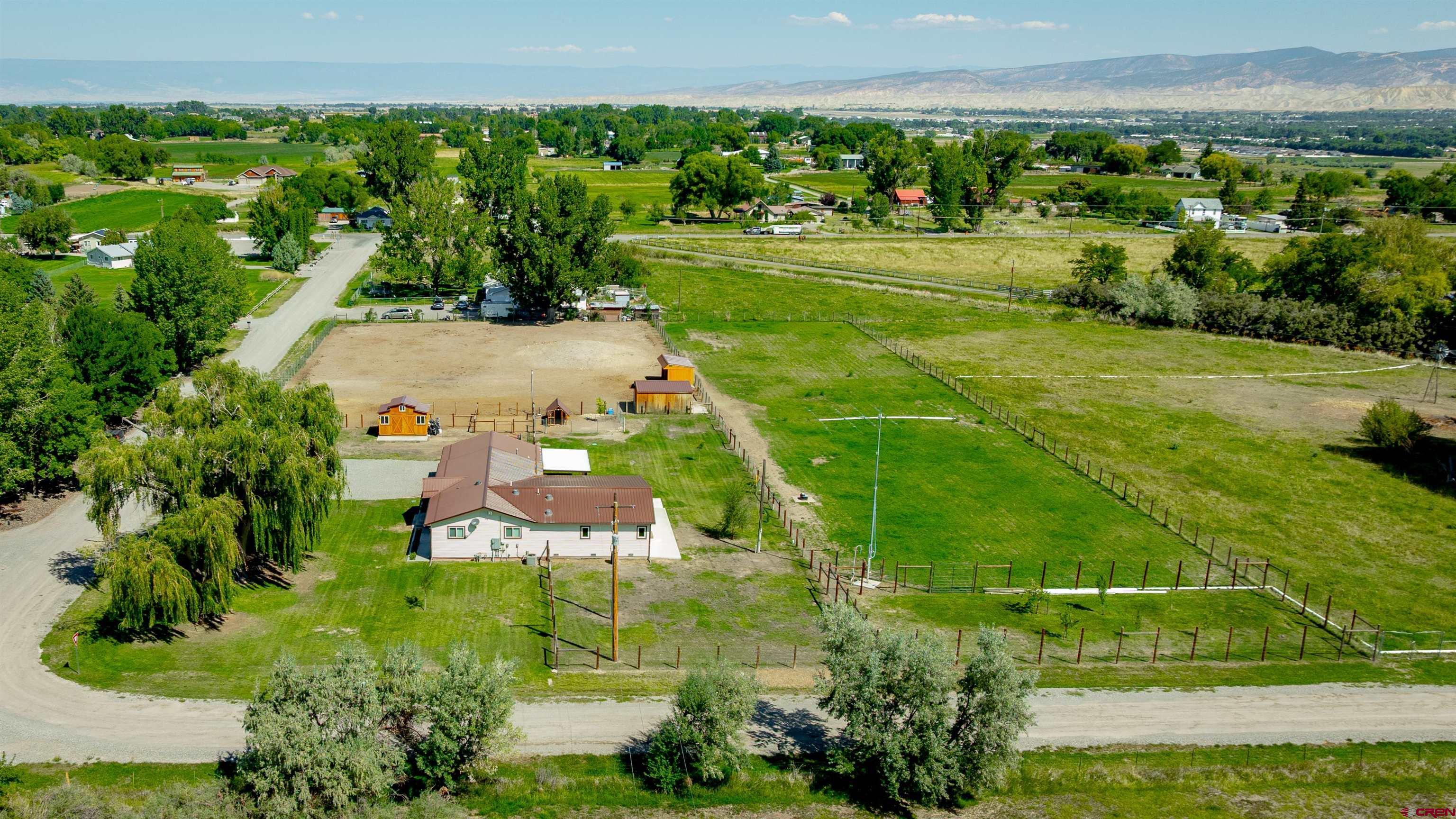 16574 6275th Road Montrose, CO 81403 - Photo 37 of 45 an aerial view of a residential houses with outdoor space and trees