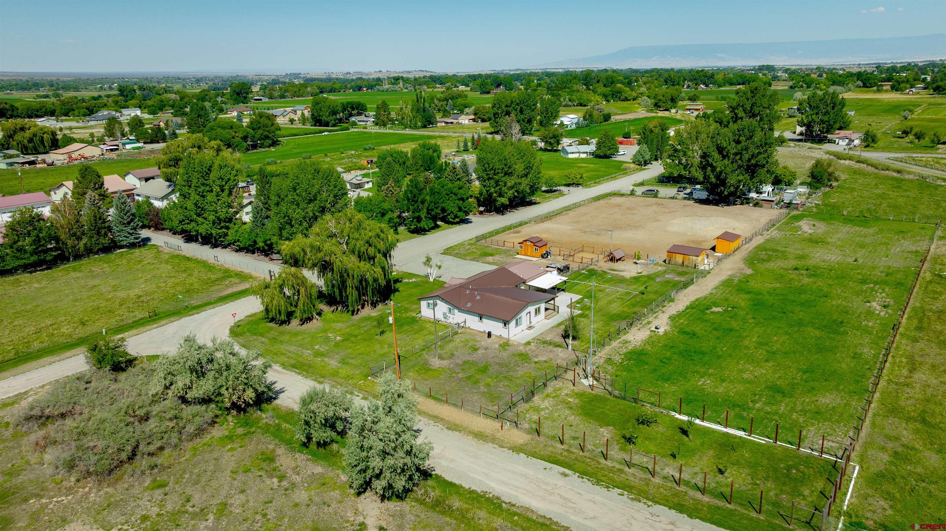 16574 6275th Road Montrose, CO 81403 - Photo 38 of 45 an aerial view of residential houses with outdoor space and trees