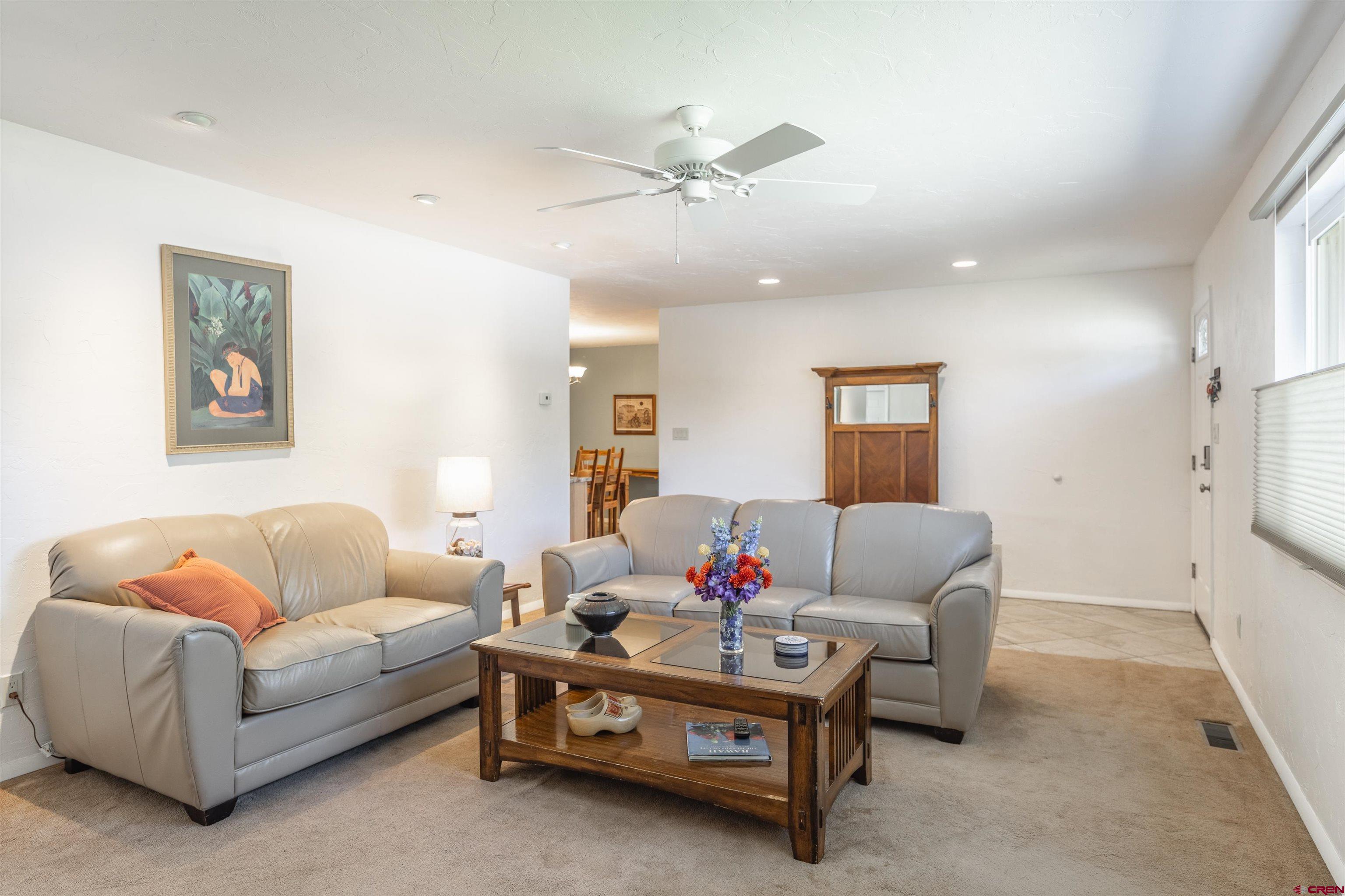 16574 6275th Road Montrose, CO 81403 - Photo 6 of 45 a living room with furniture and a chandelier