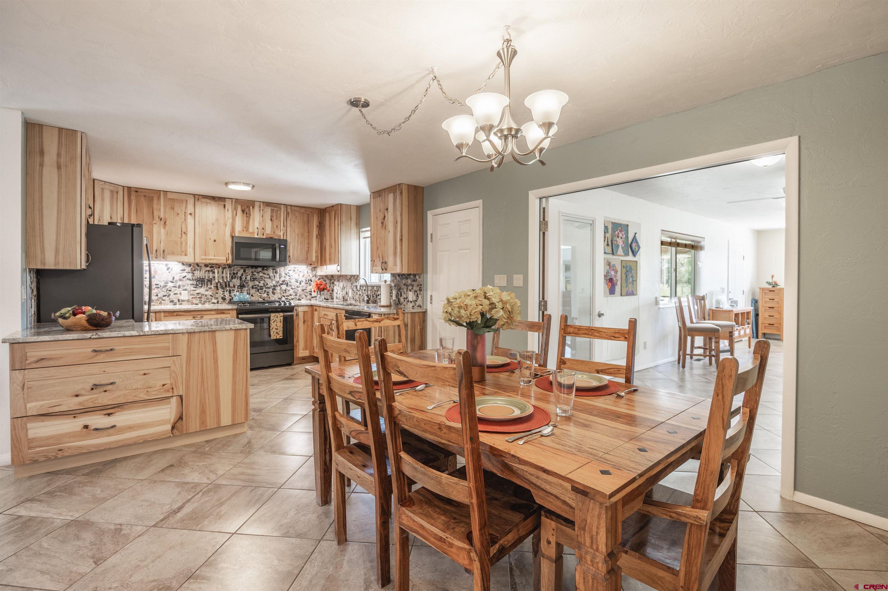 16574 6275th Road Montrose, CO 81403 - Photo 8 of 45 a view of a dining room with furniture and a chandelier